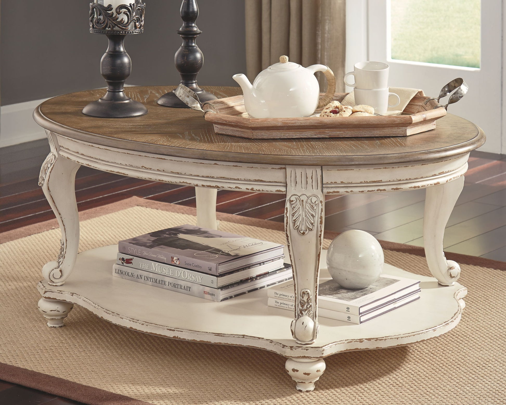 Realyn - White / Brown - Oval Cocktail Table - Hornell Furniture Outlet