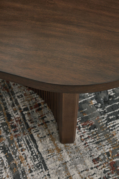 Korestone - Dark Brown - Oval Cocktail Table - Hornell Furniture Outlet
