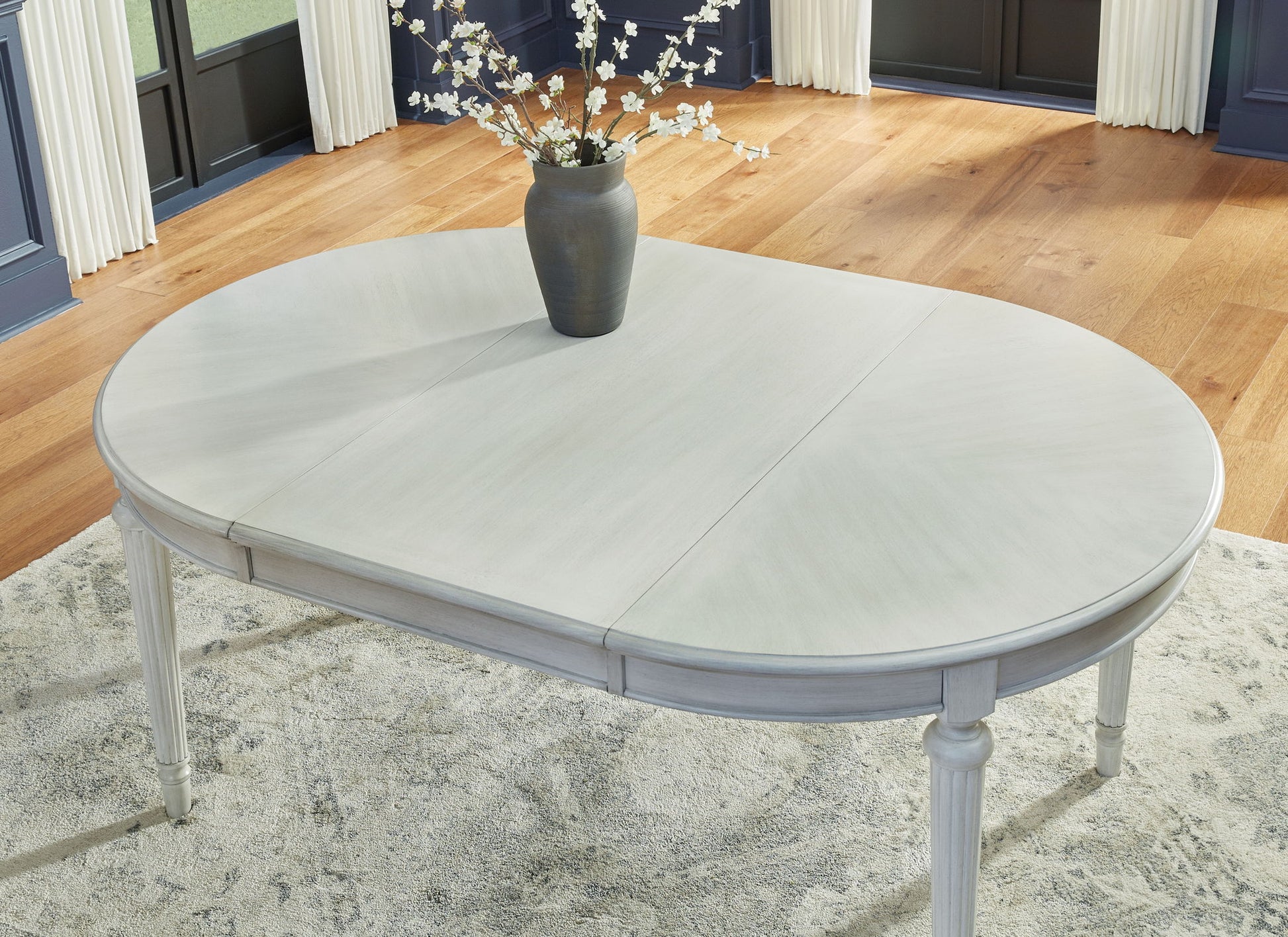 Montelaine - Antique White - Oval Dining Room Extension Table - Hornell Furniture Outlet