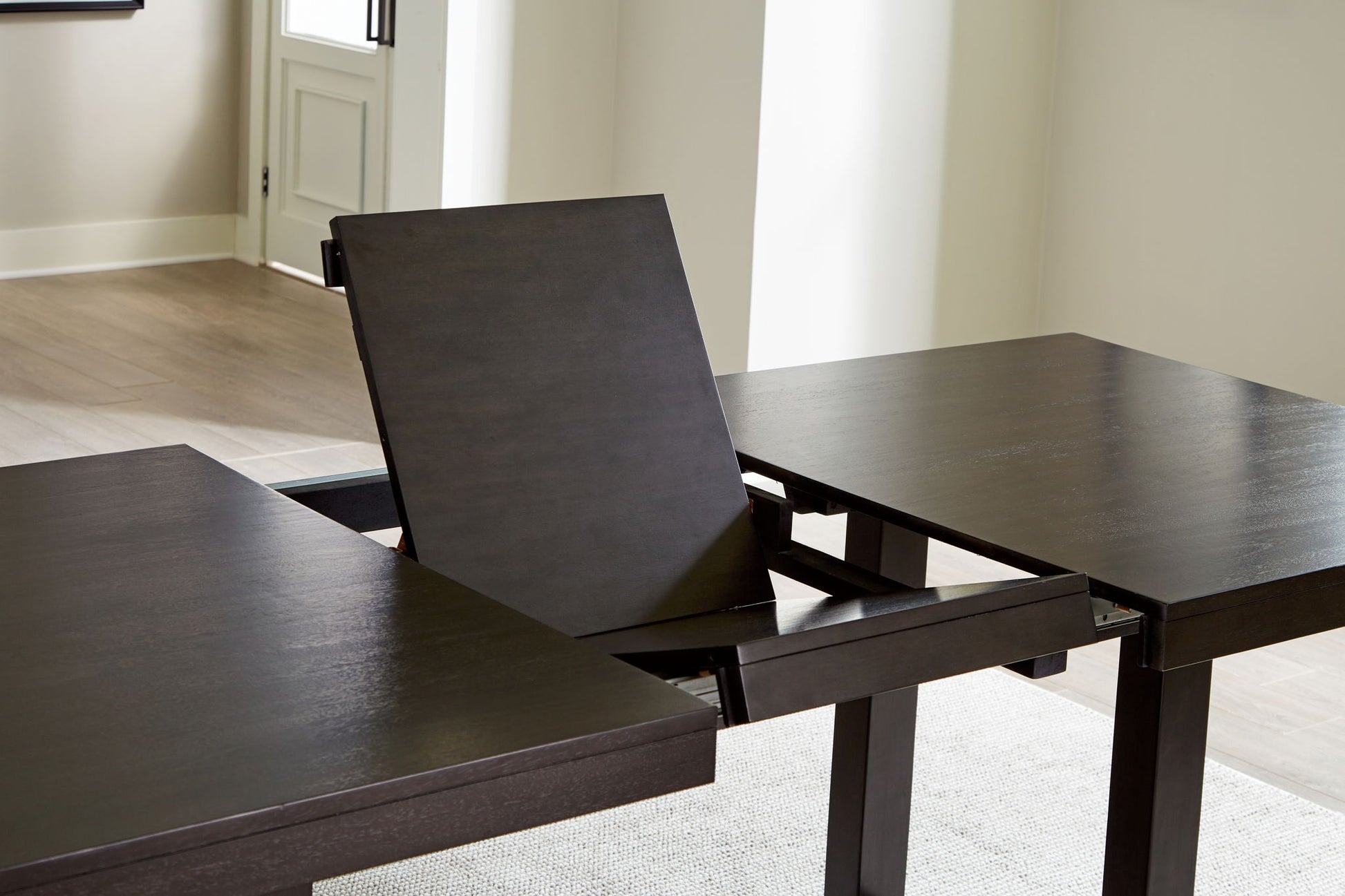 Neymorton - Dark Grayish Brown - Rectangular Dining Room Butterfly Extension Table - Hornell Furniture Outlet