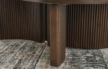 Korestone - Dark Brown - Oval Cocktail Table - Hornell Furniture Outlet