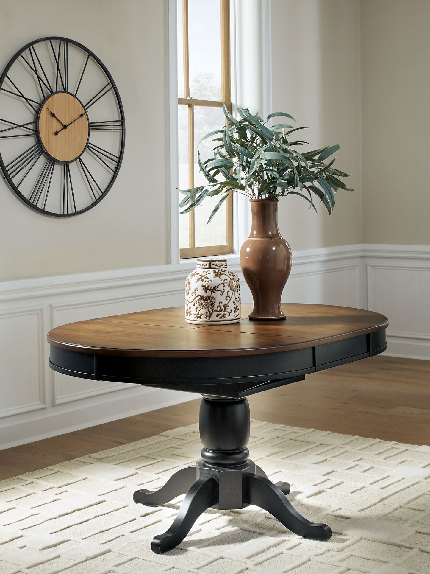 Clorazi - Oval Dining Room Butterfly Extension Table - Black / Brown - Hornell Furniture Outlet
