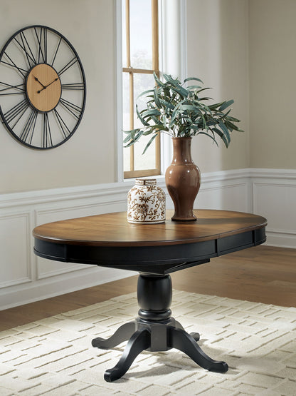 Clorazi - Oval Dining Room Butterfly Extension Table - Black / Brown - Hornell Furniture Outlet