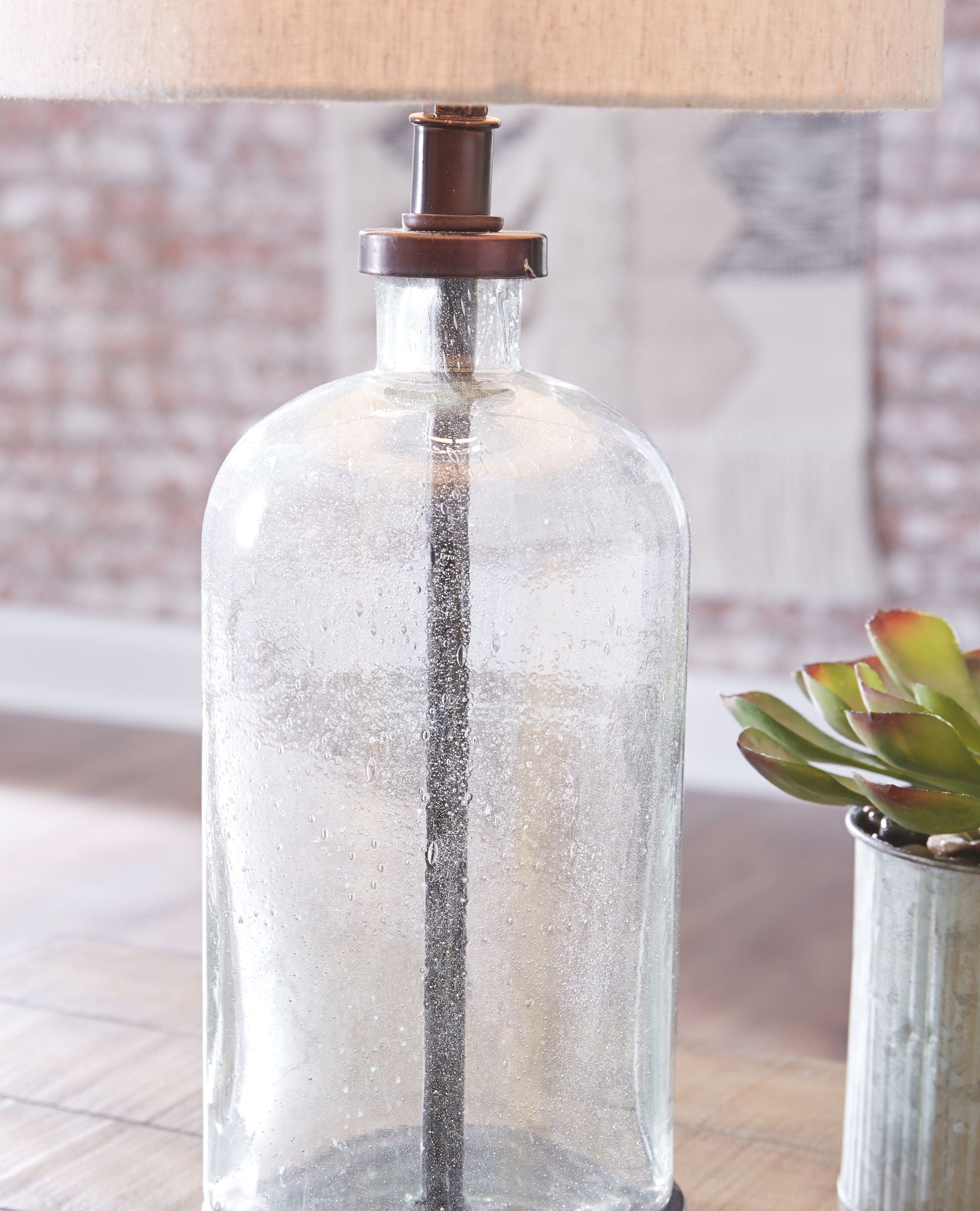 Bandile - Clear / Bronze Finish - Glass Table Lamp - Hornell Furniture Outlet