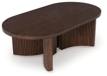 Korestone - Dark Brown - Oval Cocktail Table - Hornell Furniture Outlet